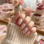 Sugarplum Sweetheart nail set displayed on a model with a soft pink glow. cut and girly