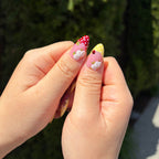 Vibrant handmade press-on nails from the Bloom & Glory collection featuring 3D white garden flowers, red and yellow polka dots, and 3D ladybug accents.