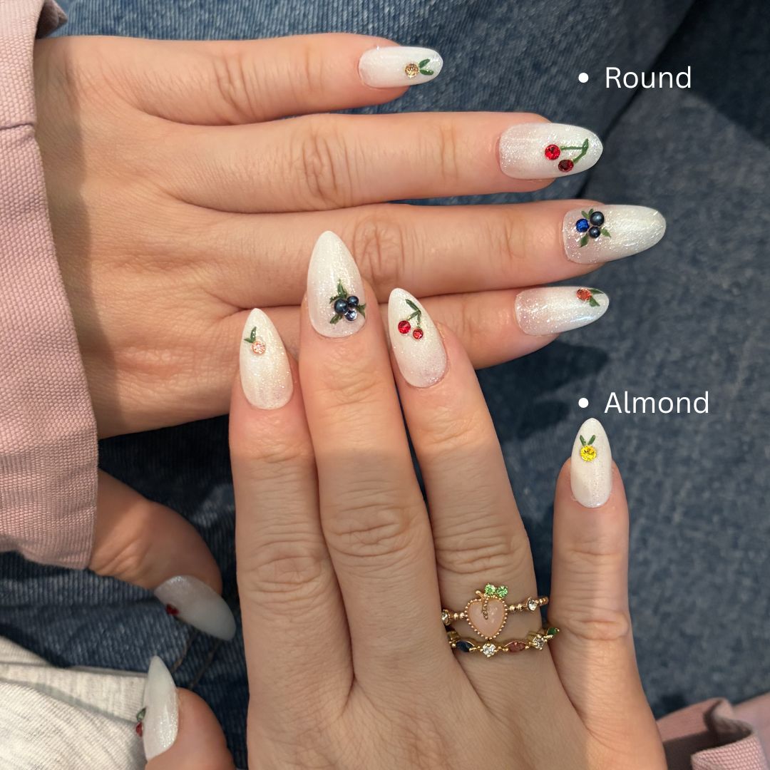 Discover "Orchard Dainties"—the latest from The Fruit Stand collection. These handmade press-on nails feature delicate hand-painted cherries and blueberries, finished with brilliant authentic Swarovski charms on a shimmering white glitter base. Perfect for a dainty, premium, and summer-ready look.