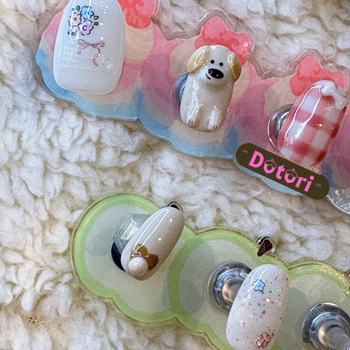 Set of decorative nail art handmade 3D cartoon characters puppy on a textured surface
