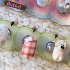 Set of decorative 3D handmade nail tips with dog cartoon characters and floral decoration. 