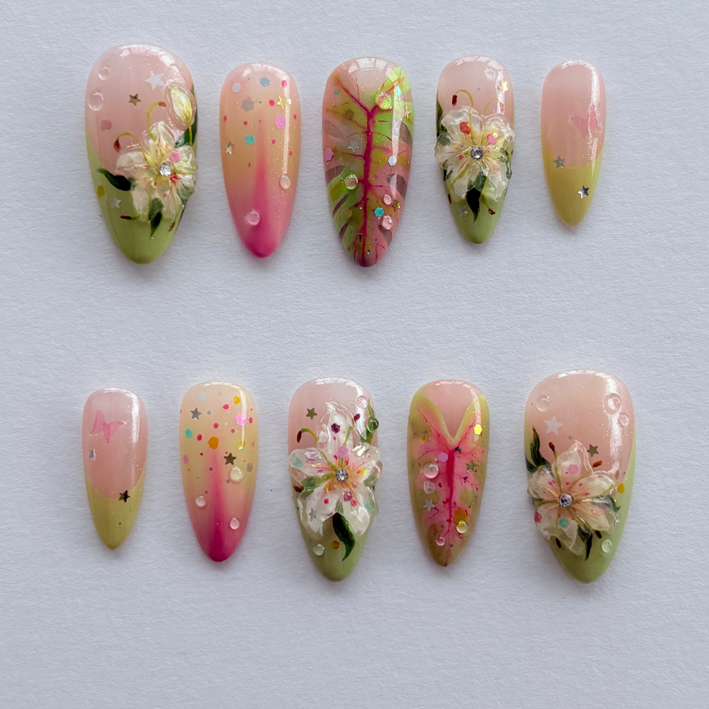 Decorative nail art with floral and gradient designs on a light gray background