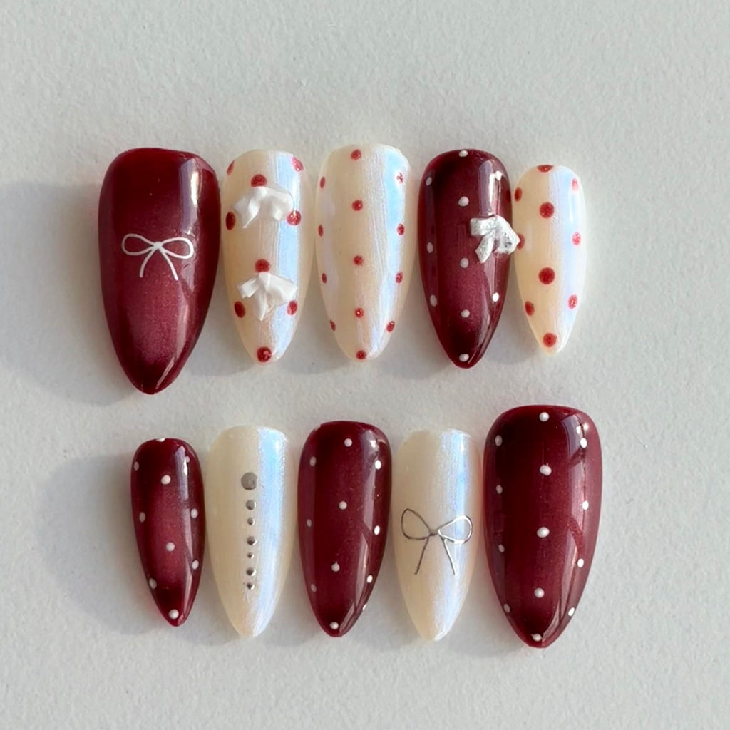 Embrace your "Red" era with the "Retro Femininity" handmade press-on nail set. Featuring bold jam-red tones, pearly iridescent ivory, and hand-painted polka dots, these nails are inspired by classic vintage glamour. Durable, confident, and salon-quality. Shop the ultimate retro manicure!