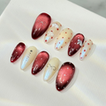 Handmade press-on nails in deep jam-red and shimmering pearly ivory with hand-painted polka dots and silver and 3d bows.