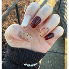 model display an elegant press on nail set with burgundy wine red, light brown with cat-eye and silvery glittery design. Polka dot