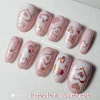 Close-up of holographic heart nail art shimmering in the light.