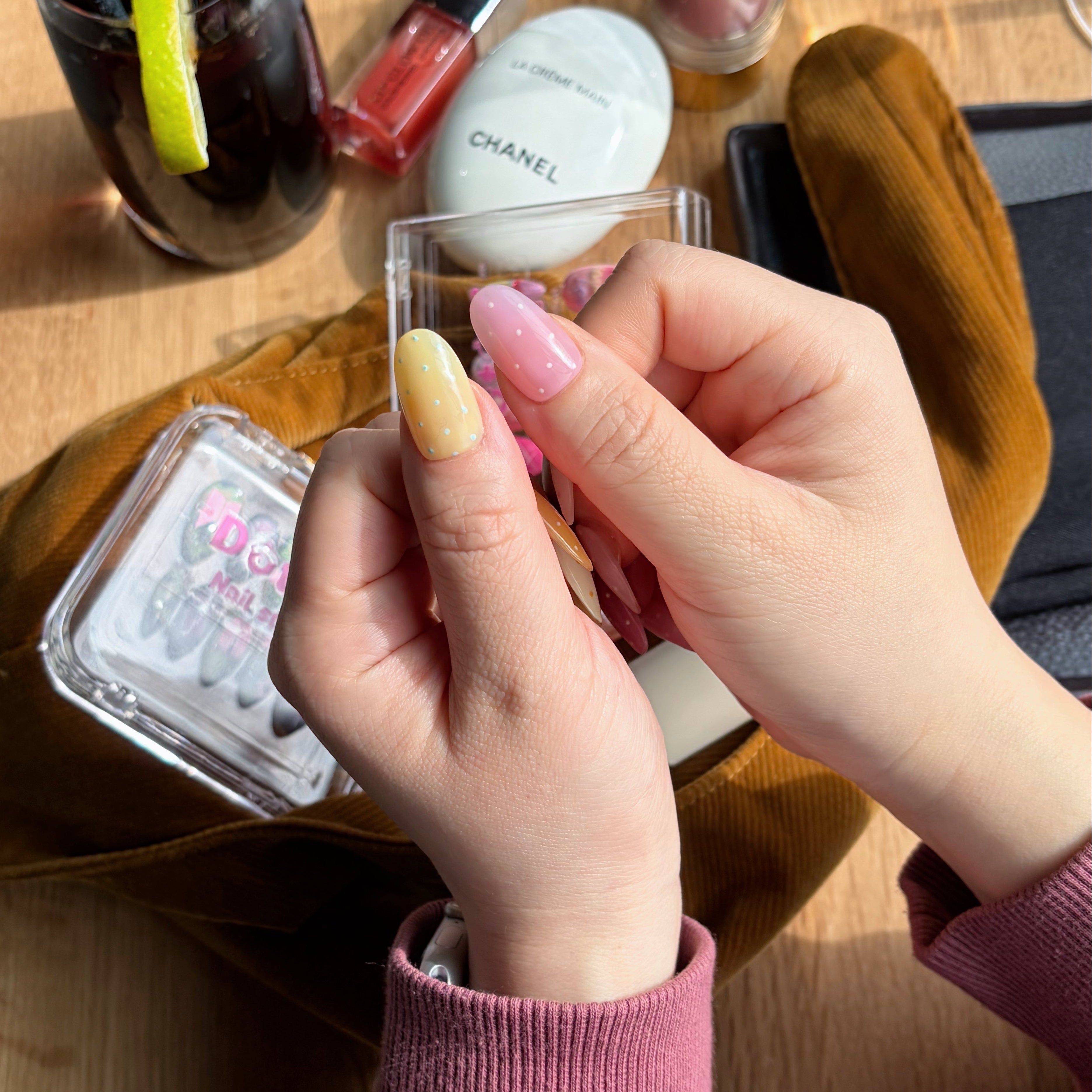 Close-up of the precise micro polka dot art and high-gloss gel finish on a soft lavender macaron-themed nail.