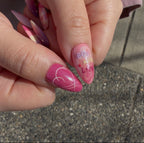 Close-up of the iridescent purple shimmer and hand-painted star motifs on a BTS-inspired nail set. Boy with luv