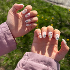 Handmade Y2K bling press-on nails with Swarovski star crystals, heart rhinestones, and pearls on a shimmering white pearl base.Channel your inner pop star with "Pixel Pixie"—handmade luxury press-on nails featuring a holographic shimmer base and a mismatched curation of authentic Swarovski star crystals and colorful rhinestones. Reusable, salon-quality, and 100% Y2K bling aesthetic.