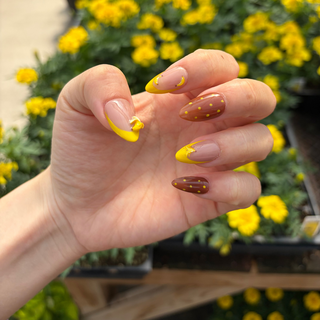Close-up of the highly detailed 3D sculpted banana charm positioned on a brilliant yellow French tip.