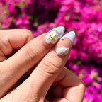 Handmade lavender press-on nails featuring 3D white flowers, 3D honeybees, white bows, and polka dot French tips with lace edges.