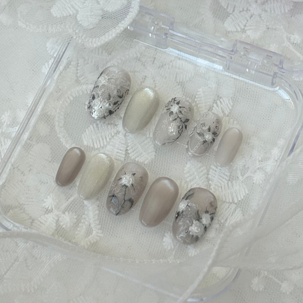 Handmade press-on nails with a soft blush pink aura gradient and unique 3D white tulle lace texture details.
