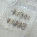 Handmade press-on nails with a soft blush pink aura gradient and unique 3D white tulle lace texture details.