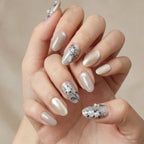 Veil Bloom nails styled with a pearl ring and a soft white fabric, highlighting a romantic bridal aesthetic.