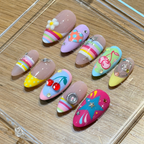 Level up your look with "Sugar Rush" from our Y2K Collection. Featuring a mismatched explosion of 3D cherry charms, hand-sculpted white flowers, rainbow candy stripes, and silver star rhinestones, these handmade luxury press-on nails deliver pure early-2000s main character energy.